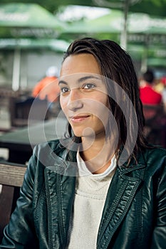 Portrait of young lady sitting at a table