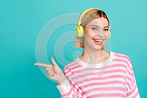 Portrait of young lady wearing striped shirt point finger mockup enjoy headphones itunes student discount isolated on photo