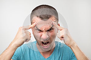 Portrait of young latin angry man. He is furious and shout with anger