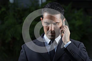 Portrait Of Young Latin Businessman Using Cell Phone photo