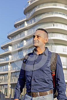 Portrait of young latino man in a city