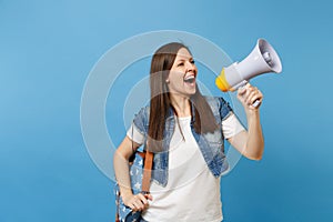 Portrait of young laughing beautiful woman student in denim clothes with backpack make announcement with megaphone