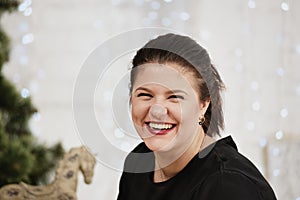 Portrait young laughing woman. Daisy background.