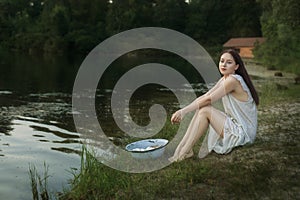 Portrait of a young laundress at the river bank