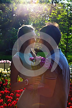 Portrait of a young in love couple near a field of tulips