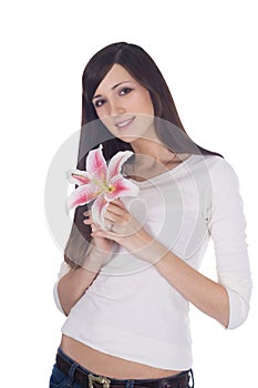 Portrait of young lovely brunette with flower in hands