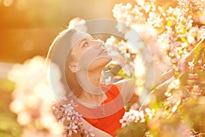 Portrait of young lovely woman in spring flowers