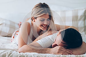Portrait of young loving couple in bedroom