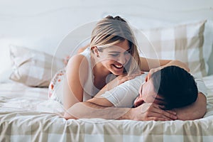 Portrait of young loving couple in bedroom