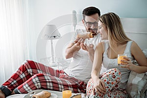 Portrait of young loving couple in bedroom