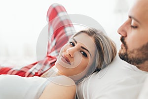 Portrait of young loving couple in bedroom