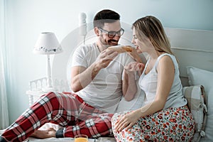 Portrait of young loving couple in bedroom