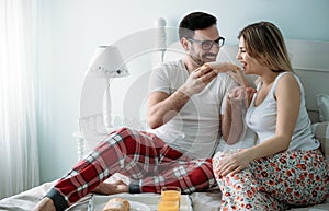 Portrait of young loving couple in bedroom