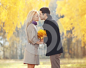 Portrait of young loving couple kissing in autumn