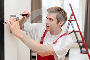 Portrait Young Male Carpenter Repairing Door Lock