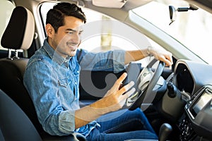 Man using phone while driving car