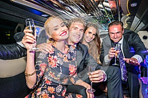 Portrait of young male and female friends with champagne flutes