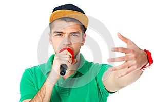 Portrait of young male hip hopper singing in studio isolated on