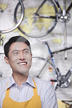 Portrait of young male mechanic in bicycle store, Beijing