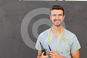 Portrait of young male nurse in scrubs smiling