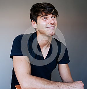 Portrait of a young male student with books