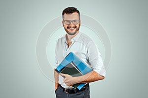 Portrait of a young male teacher on a light background. Teacher`s Day Knowledge Day back to school study online learning