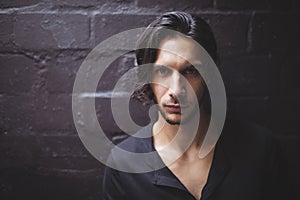 Portrait of young man against wall photo