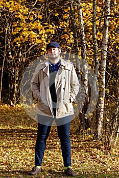 Portrait of young man in autumn forest