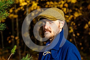 Portrait of young man in autumn forest