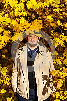 Portrait of young man in autumn forest