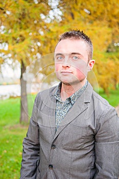 Portrait of young man in autumn park