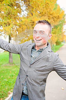 Portrait of young man in autumn park