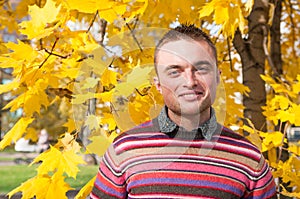 Portrait of young man in autumn park