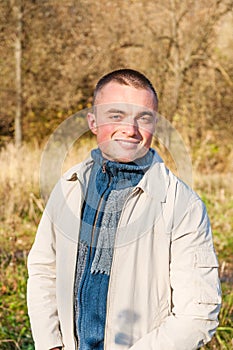 Portrait of young man in autumn park