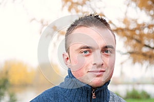 Portrait of young man in autumn park