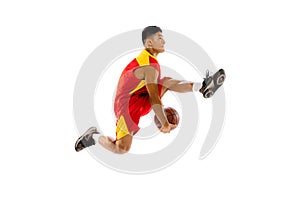 Portrait of young man, basketball player isolated over white studio background. High jump with ball