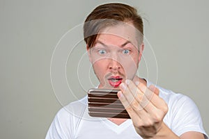 Portrait of young man with beard stubble wearing makeup