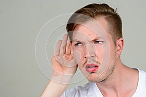 Portrait of young man with beard stubble wearing makeup