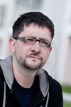 Portrait of a young man with beard wearing glasses