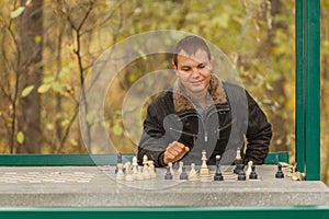 Portrait of young man in black jacket in gazebo photo