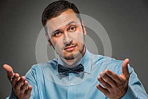 Portrait young man in blue shirt, looking at the camera