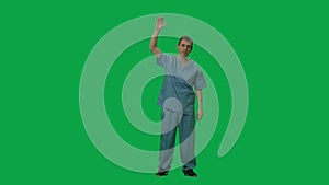 Portrait of young man in a blue suit of a surgeon doctor dancing and waving his arms. Full length on green screen