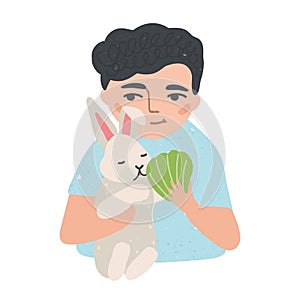 Portrait of young man or boy holding his bunny or rabbit and feeding it. Adorable male cartoon character with domestic