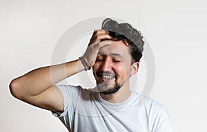 Portrait of a young man with braces smiling. A happy young man with braces on a white background