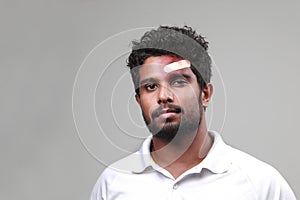 Portrait of a young man  with a bruised forehead