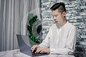 Portrait of young man businessman working  at  office with laptop on desk