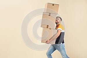 Portrait of young man carrying carton boxes