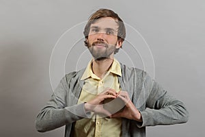 Portrait of young man doing heart gesture