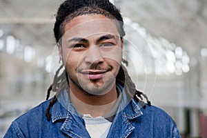 Portrait of young man with dreadlocks