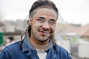 Portrait of young man with dreadlocks